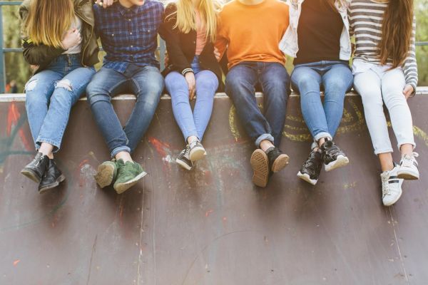 group of people sitting on wall