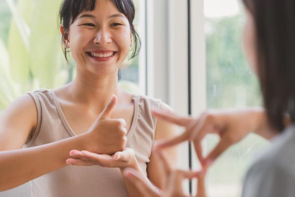 two women conversing in American Sign Language